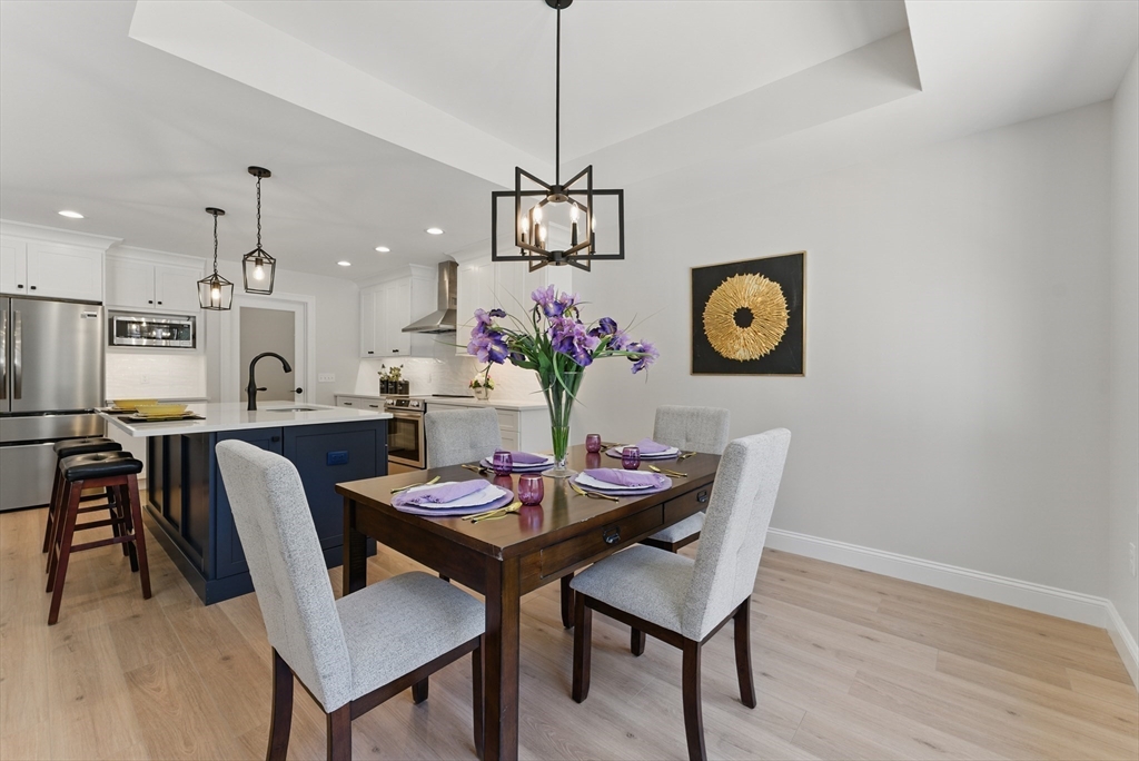 18 Nicols Way, Unit 18 Easthampton, MA 01027 - Photo 13 of 40 a view of a dining room with furniture wooden floor and chandelier
