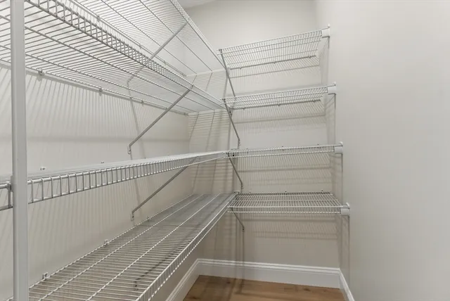 a view of walk in closet with empty racks