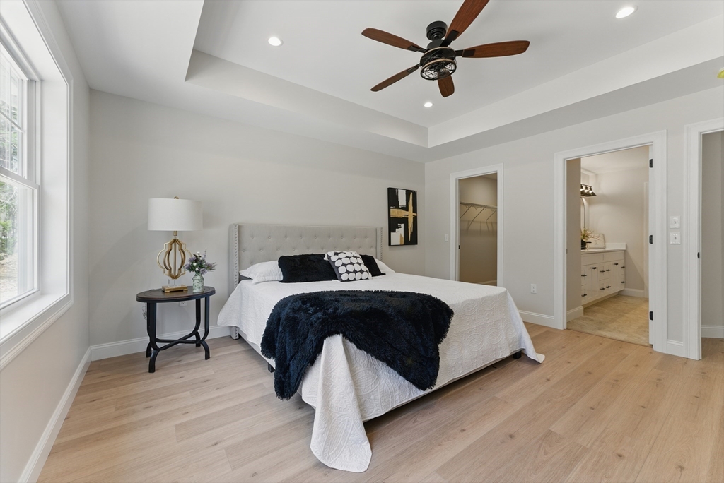 18 Nicols Way, Unit 18 Easthampton, MA 01027 - Photo 18 of 40 a spacious bedroom with a bed and a chandelier