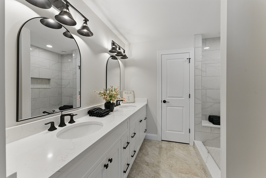 18 Nicols Way, Unit 18 Easthampton, MA 01027 - Photo 21 of 40 a bathroom with a double vanity sink and mirror