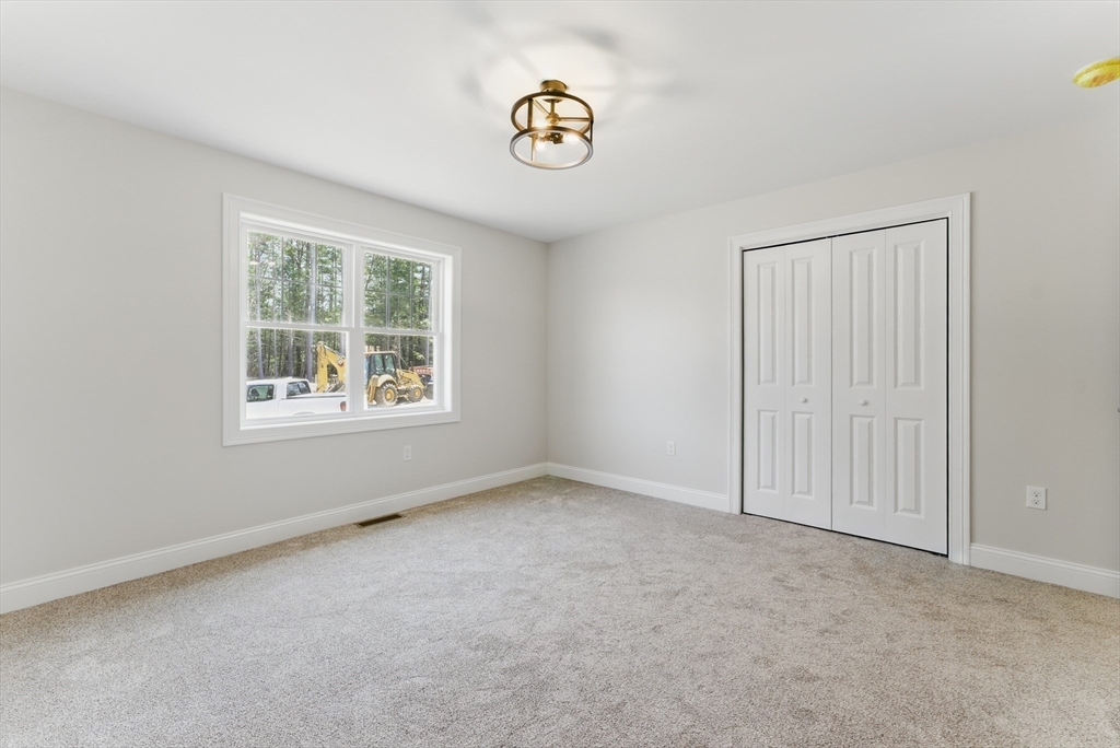 18 Nicols Way, Unit 18 Easthampton, MA 01027 - Photo 27 of 40 an empty room with windows and closet