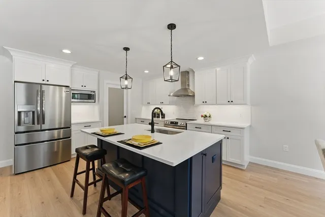 a kitchen with refrigerator cabinets and wooden floor