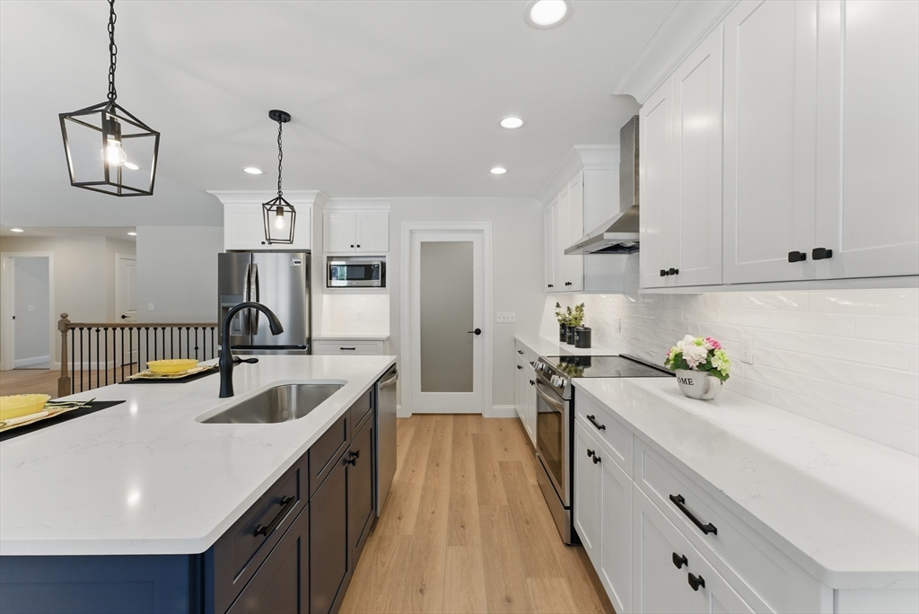 18 Nicols Way, Unit 18 Easthampton, MA 01027 - Photo 9 of 40 a kitchen with kitchen island granite countertop a sink a counter space appliances and cabinets