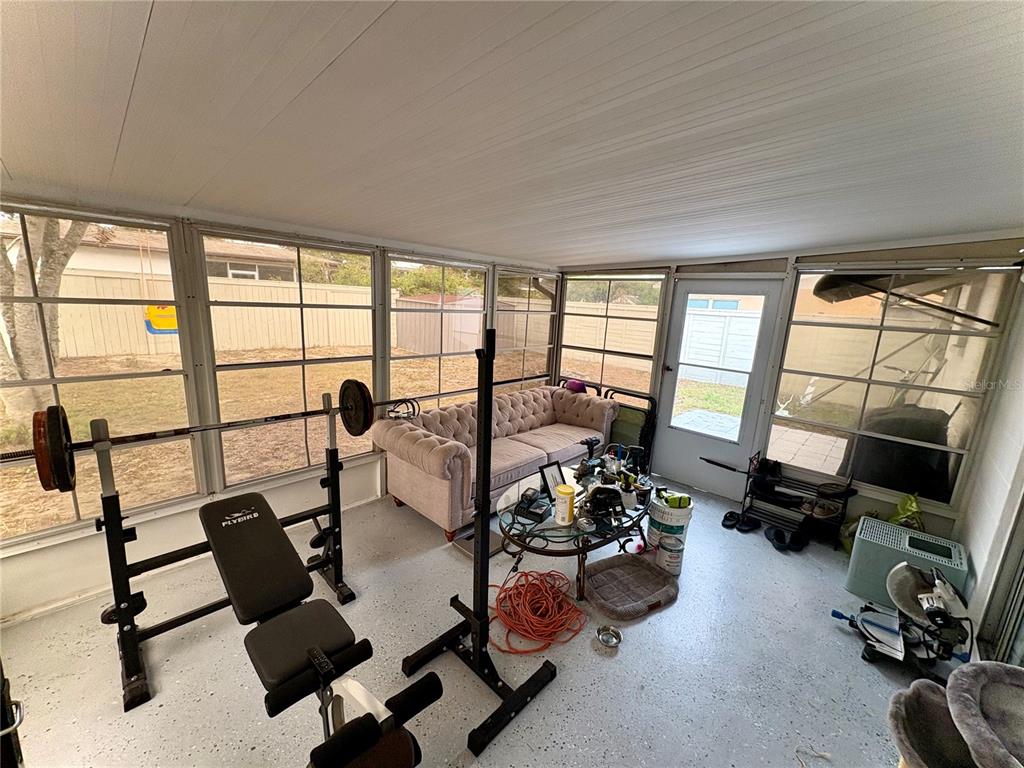 8501 Paxton Drive Port Richey, FL 34668 - Photo 11 of 17 a living room with furniture and floor to ceiling windows