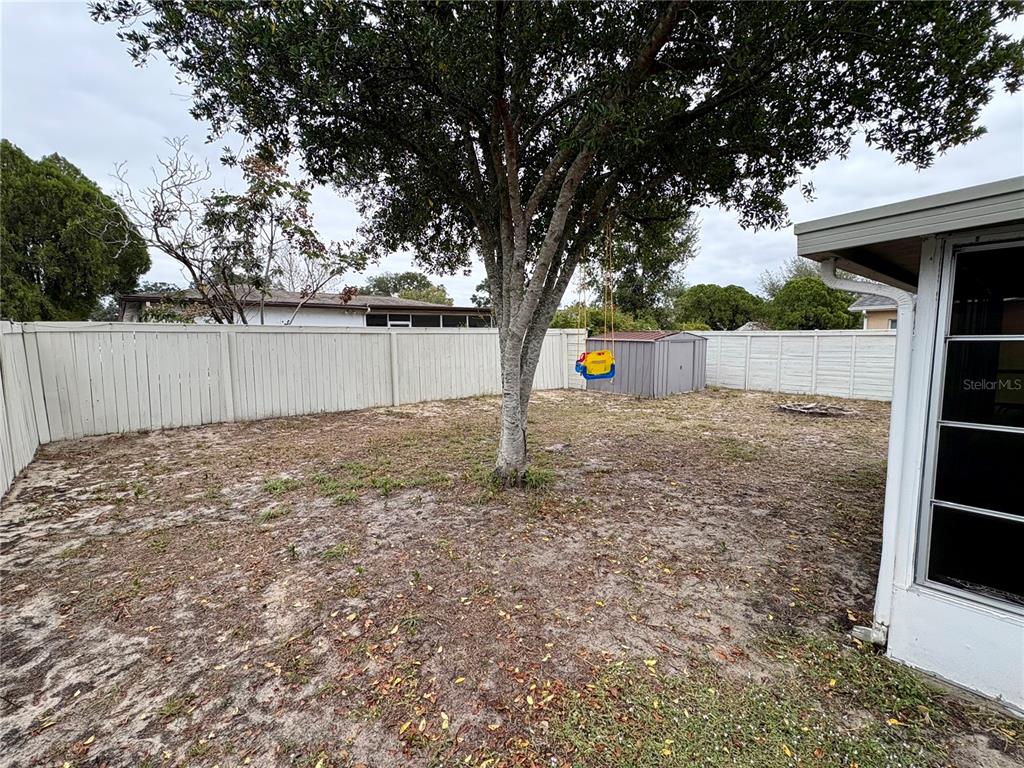 8501 Paxton Drive Port Richey, FL 34668 - Photo 16 of 17 a backyard of a house with lots of green space