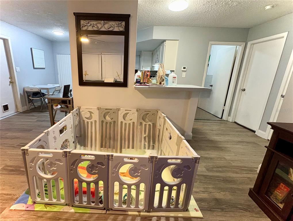 8501 Paxton Drive Port Richey, FL 34668 - Photo 3 of 17 a view of a kitchen with furniture and wooden floor
