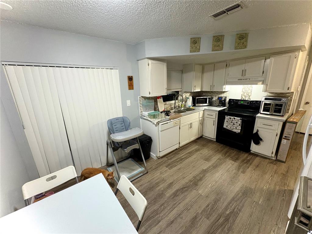 8501 Paxton Drive Port Richey, FL 34668 - Photo 6 of 17 a kitchen with a sink appliances and cabinets