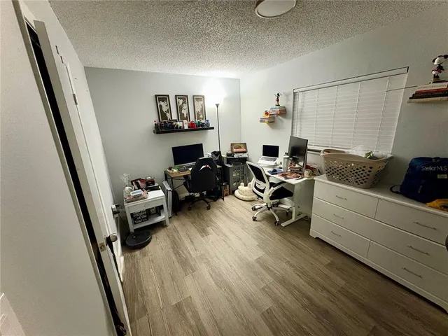 a bedroom with furniture and a wooden floor