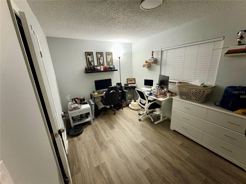 8501 Paxton Drive Port Richey, FL 34668 - Photo 10 of 17 a bedroom with furniture and a wooden floor