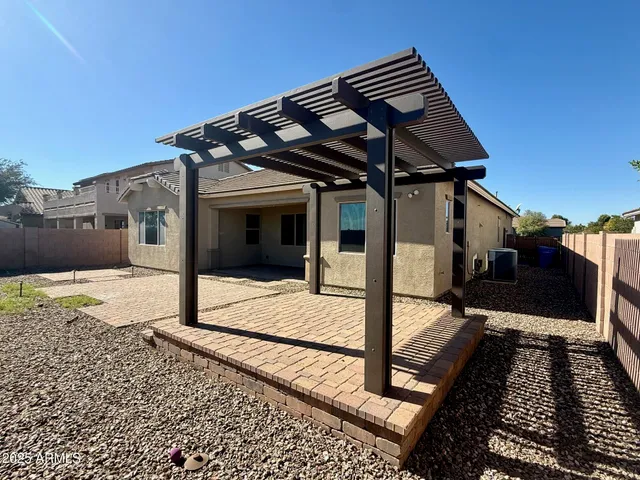 a backyard of a house with table and chairs