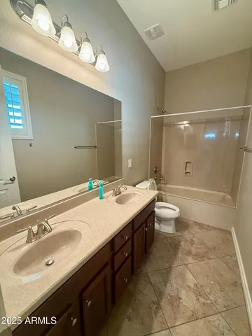 an empty room with a ceiling fan and window