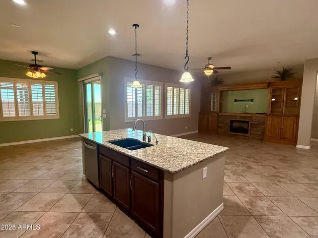 a kitchen with stainless steel appliances granite countertop a stove top oven a sink and a microwave