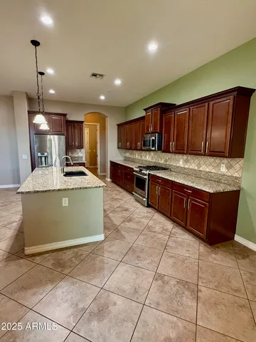 a stove top oven sitting inside of a kitchen