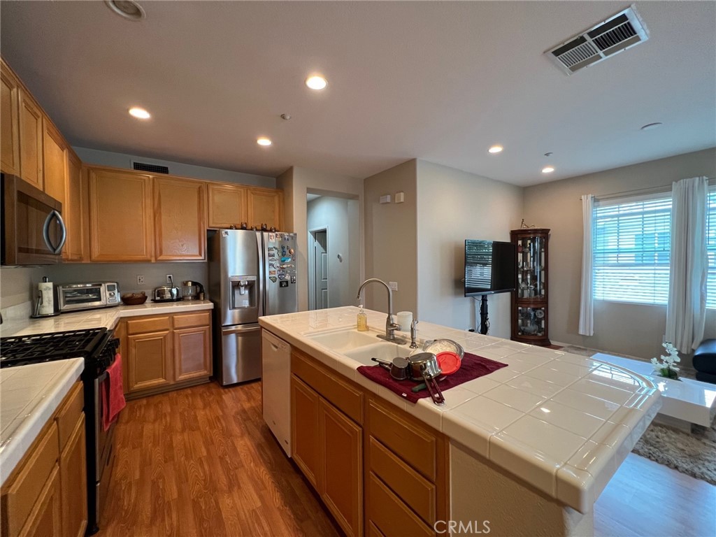 10 Chilmark Street Ladera Ranch, CA 92694 - Photo 2 of 16 a kitchen that has a lot of cabinets a sink and appliances