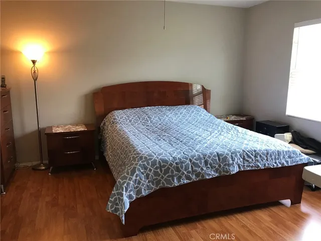 a bedroom with a bed and a night stand