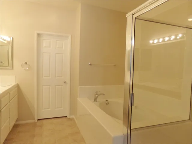 a bathroom with a bathtub and shower
