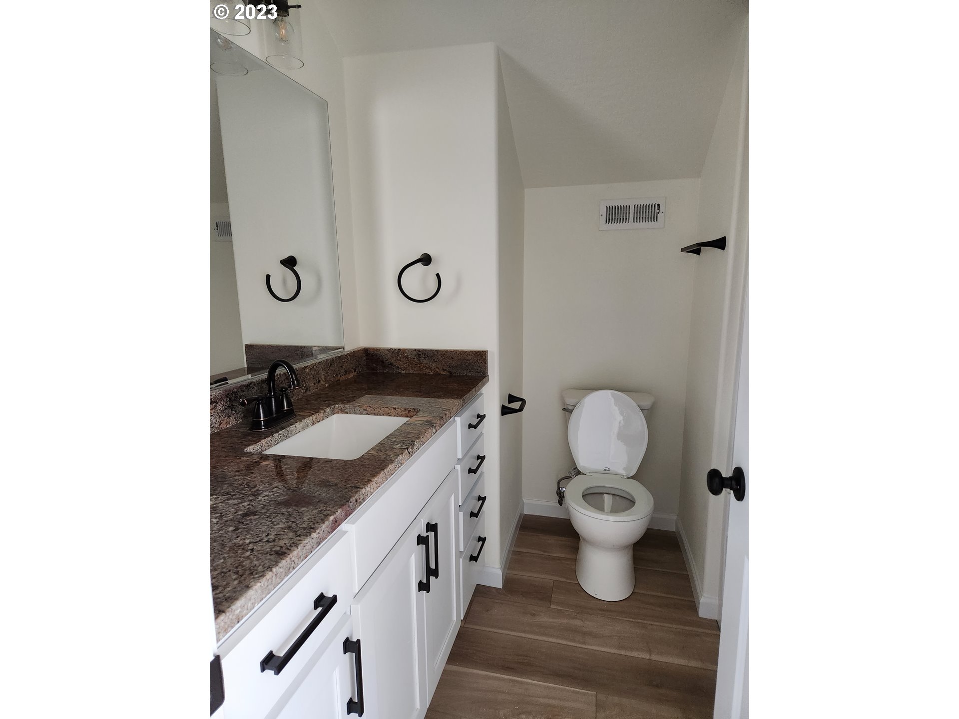 5595 B Street Springfield, OR 97478 - Photo 20 of 26 a bathroom with a granite countertop sink and a toilet