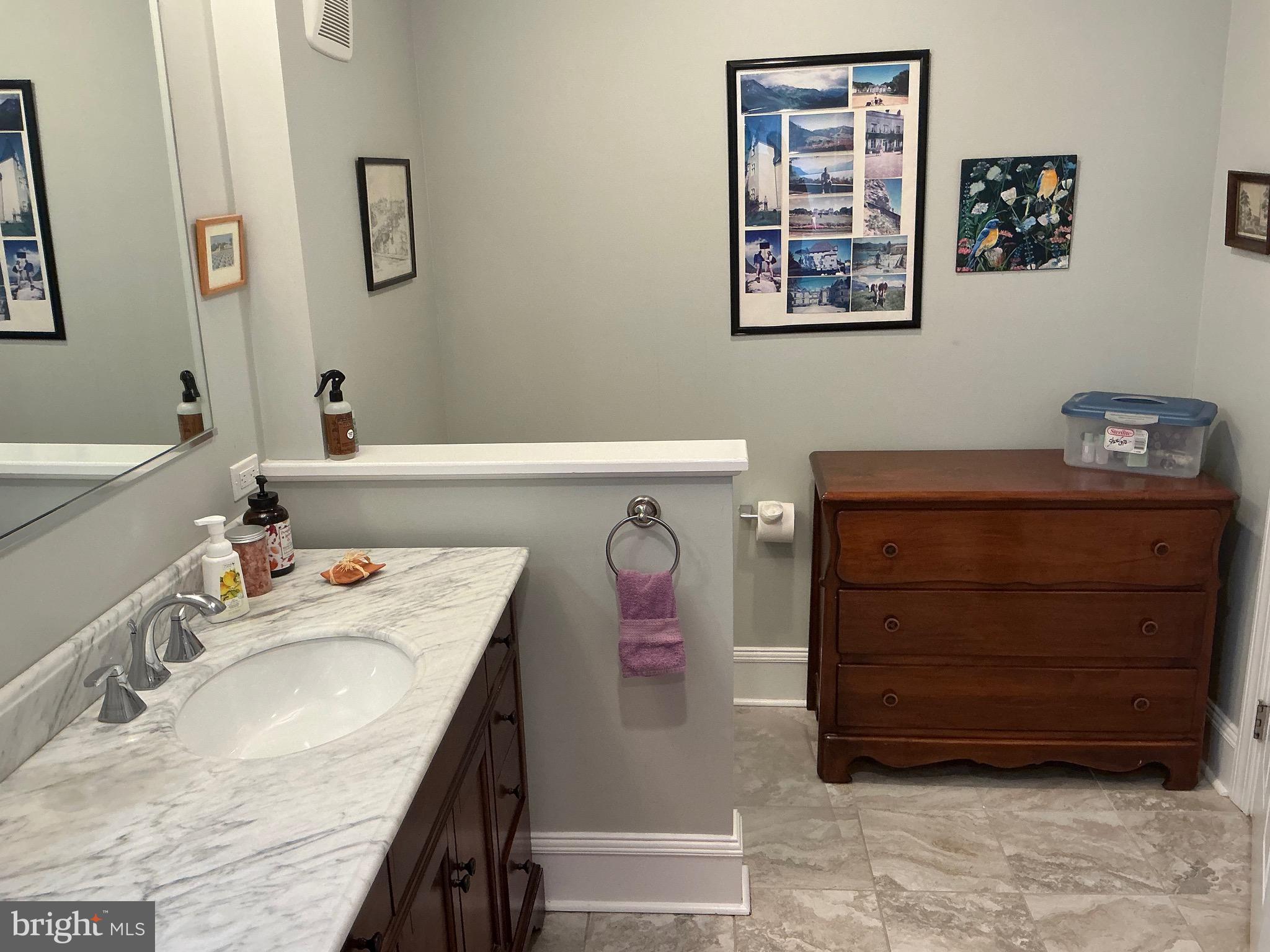 29 Centre Street Haddonfield, NJ 08033 - Photo 23 of 39 a bathroom with a tub sink and mirror