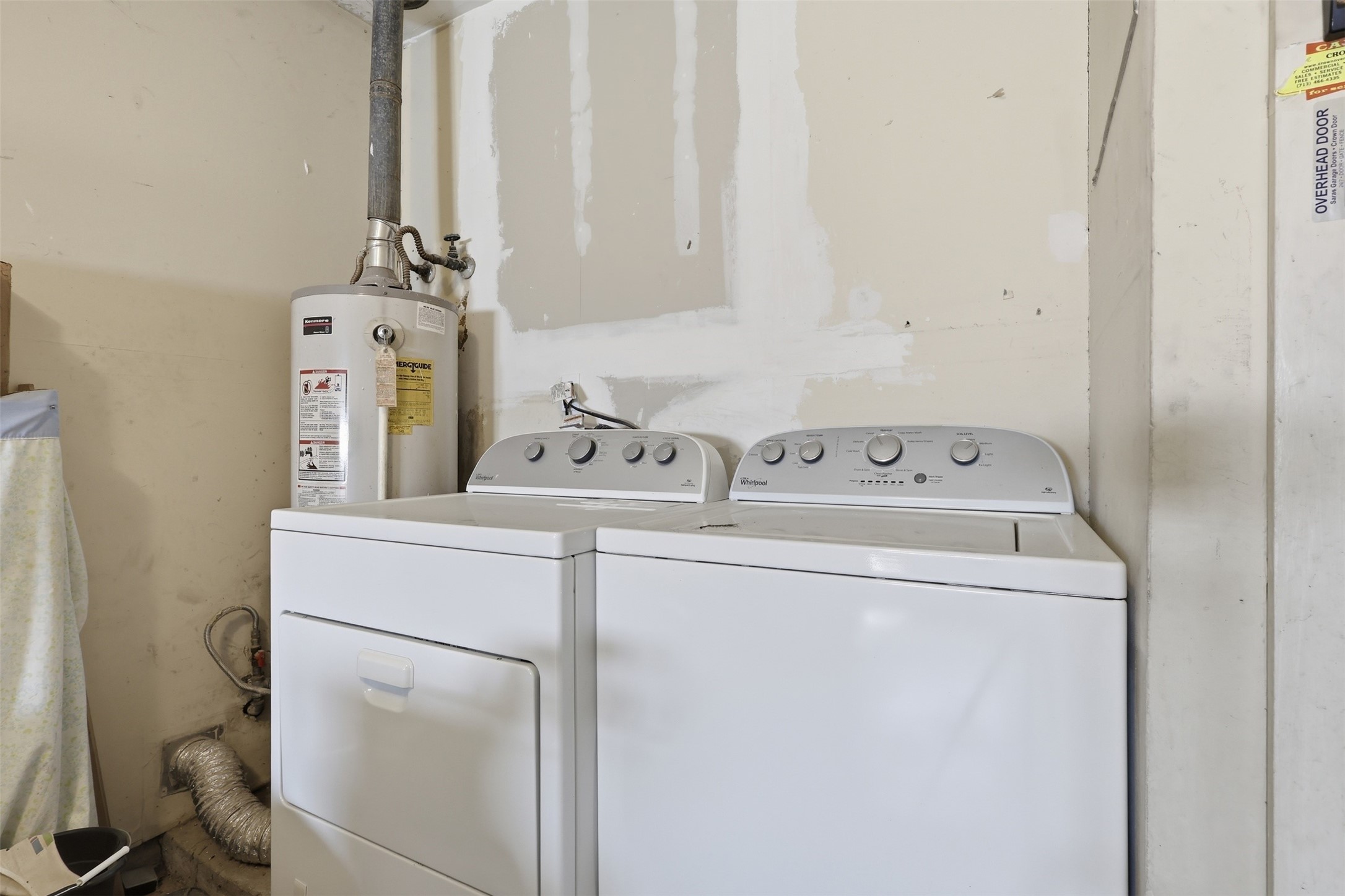 5707 Waltrip Street Houston, TX 77087 - Photo 12 of 15 This photo shows a laundry area with a washer and dryer, alongside a water heater.