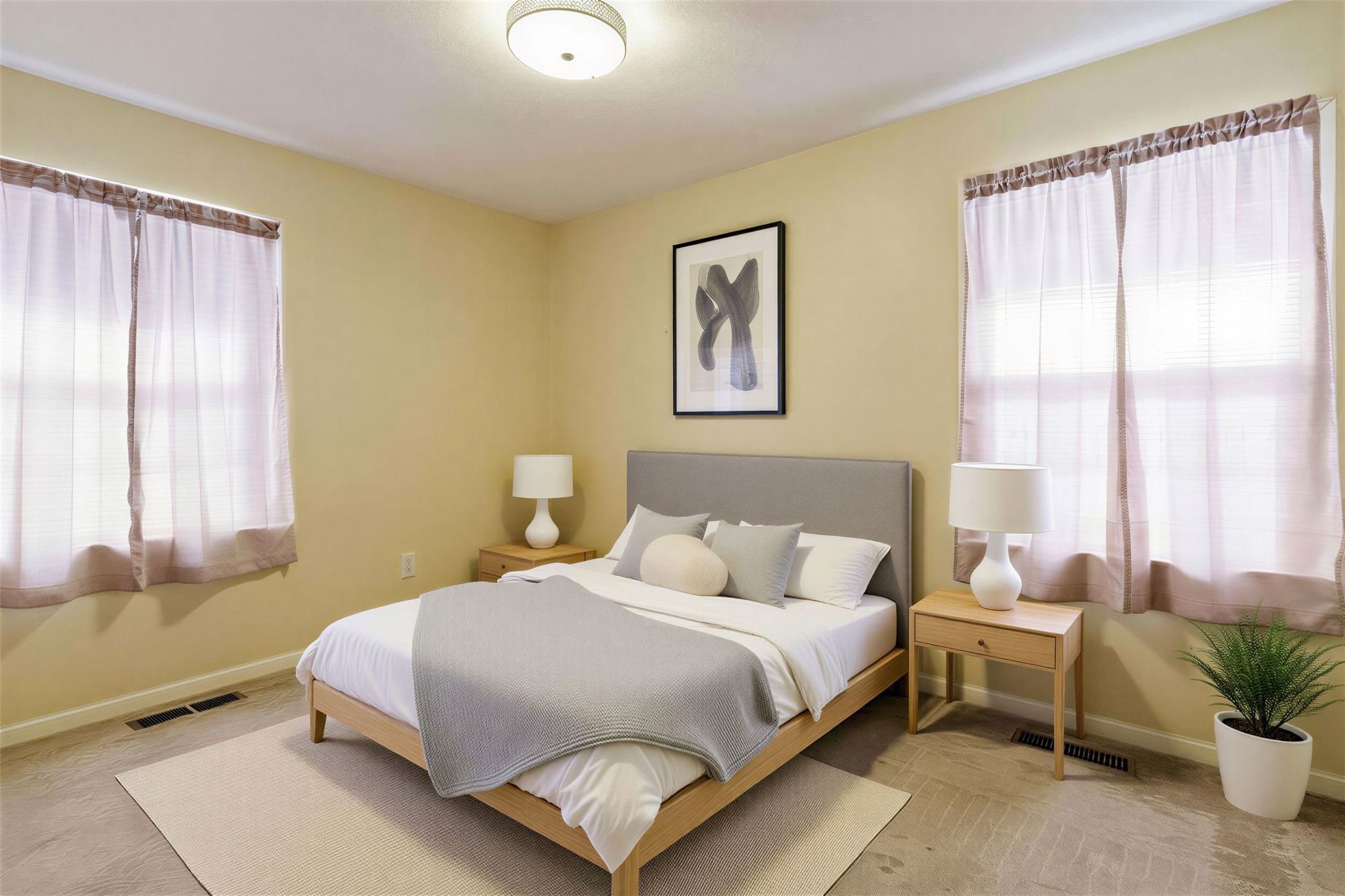 5707 Waltrip Street Houston, TX 77087 - Photo 9 of 15 This is a cozy primary bedroom featuring soft lighting, neutral walls, and two windows.