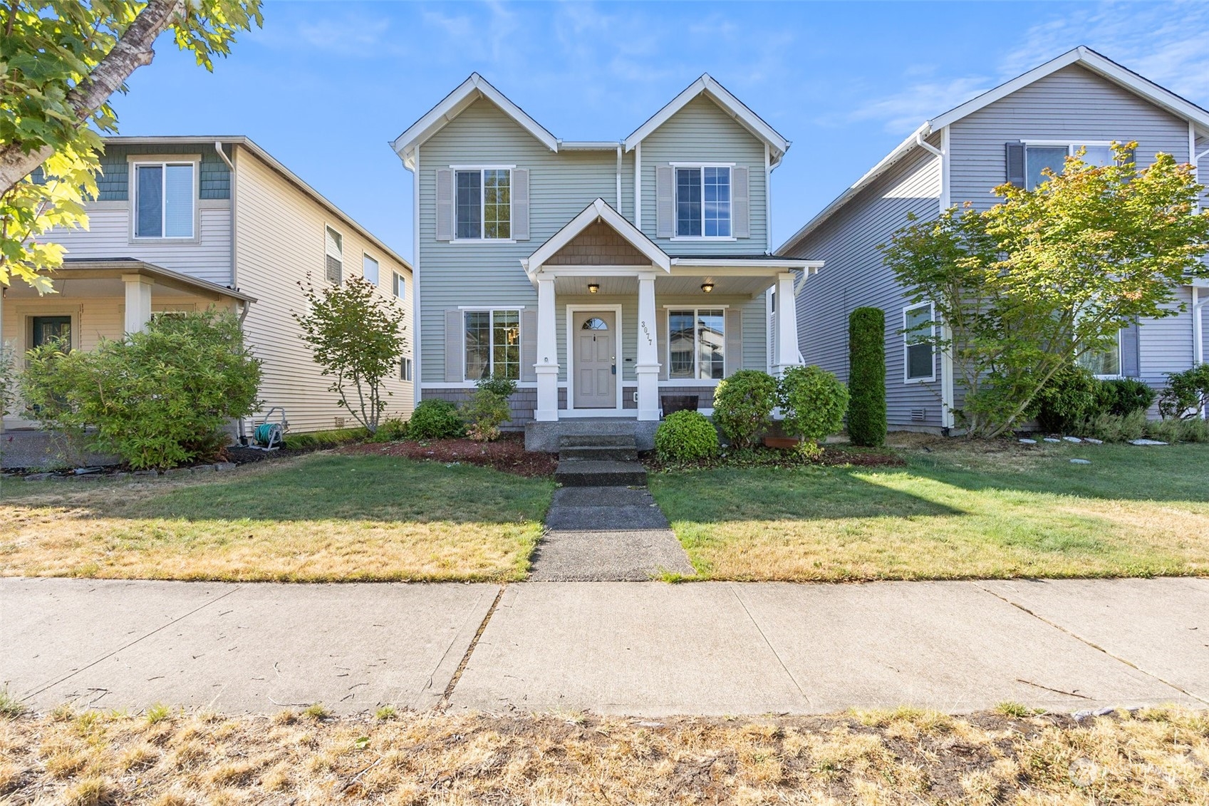 3077 Walker Road DuPont, WA 98327 - Photo 1 of 30 a front view of a house with a yard and garage