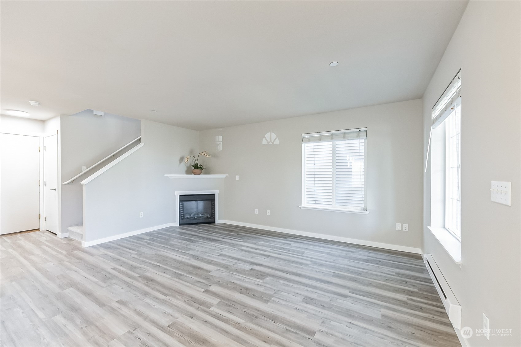 3077 Walker Road DuPont, WA 98327 - Photo 11 of 30 a view of a livingroom with wooden floor and staircase