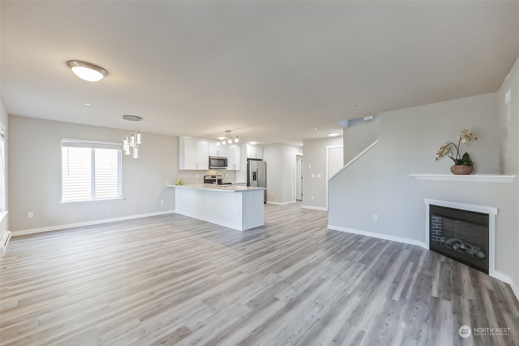 3077 Walker Road DuPont, WA 98327 - Photo 12 of 30 a view of empty room with wooden floor and fireplace