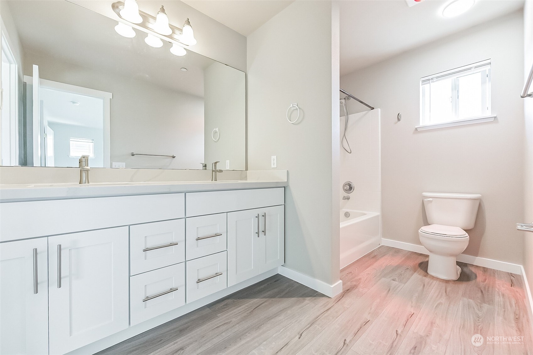 3077 Walker Road DuPont, WA 98327 - Photo 21 of 30 a spacious bathroom with a double vanity sink a mirror and a toilet