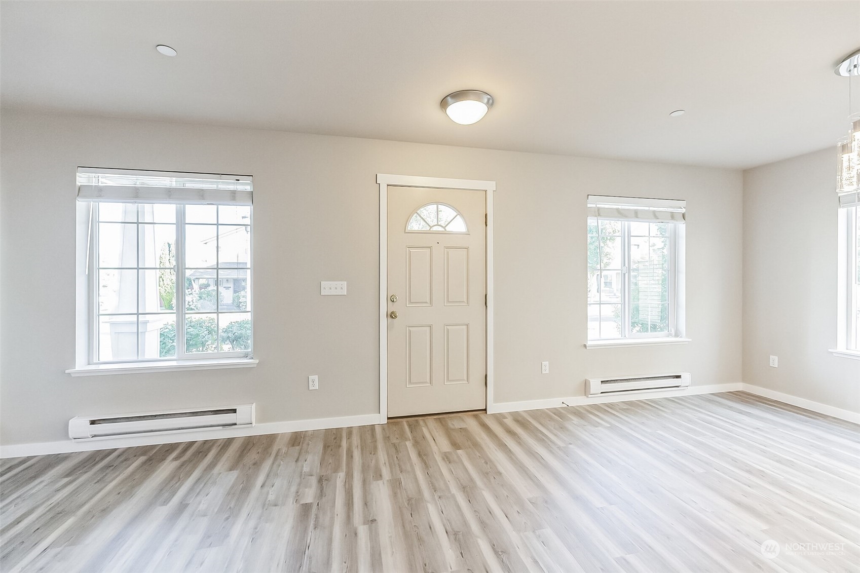 3077 Walker Road DuPont, WA 98327 - Photo 5 of 30 an empty room with wooden floor and windows
