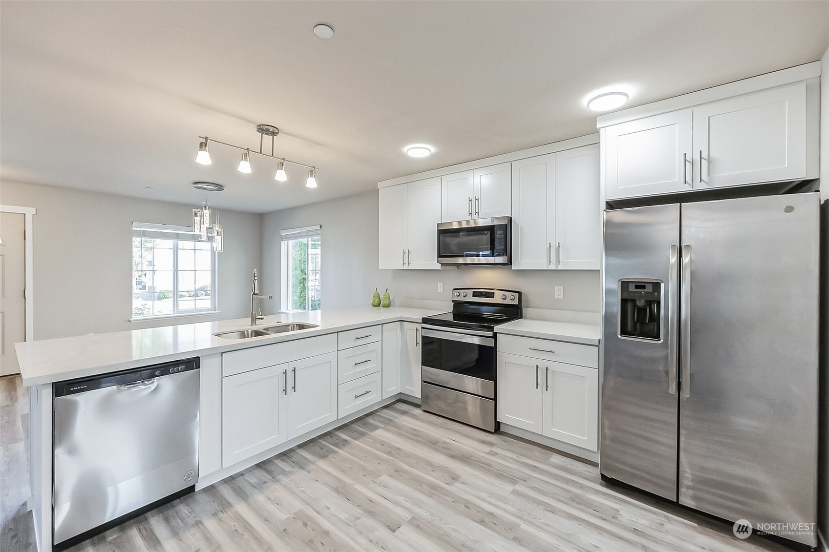 3077 Walker Road DuPont, WA 98327 - Photo 6 of 30 a kitchen with white cabinets stainless steel appliances and a window