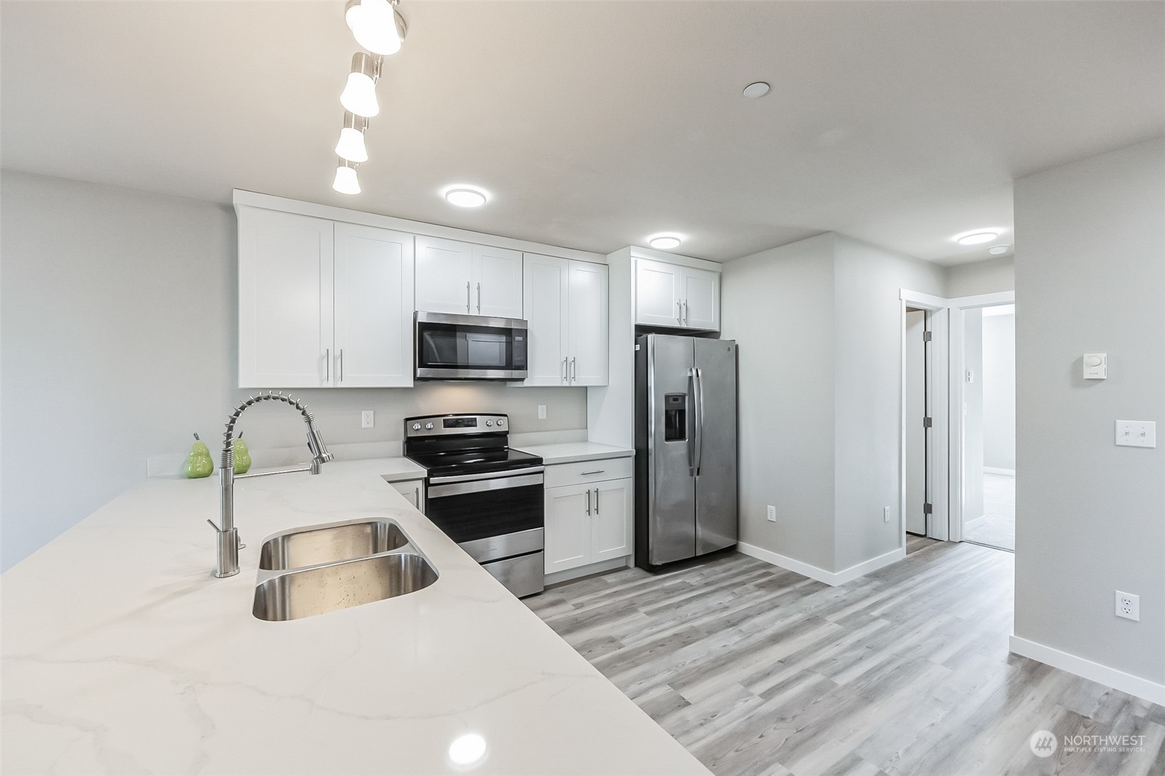 3077 Walker Road DuPont, WA 98327 - Photo 8 of 30 a kitchen that has a sink stainless steel appliances a refrigerator cabinets and a sink