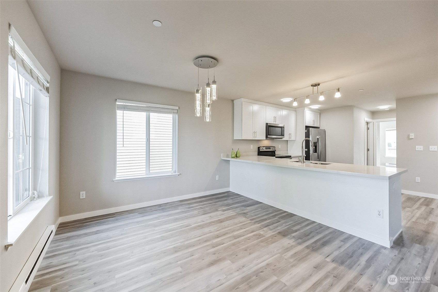 3077 Walker Road DuPont, WA 98327 - Photo 10 of 30 a view of kitchen with kitchen island stainless steel appliances wooden floor and window