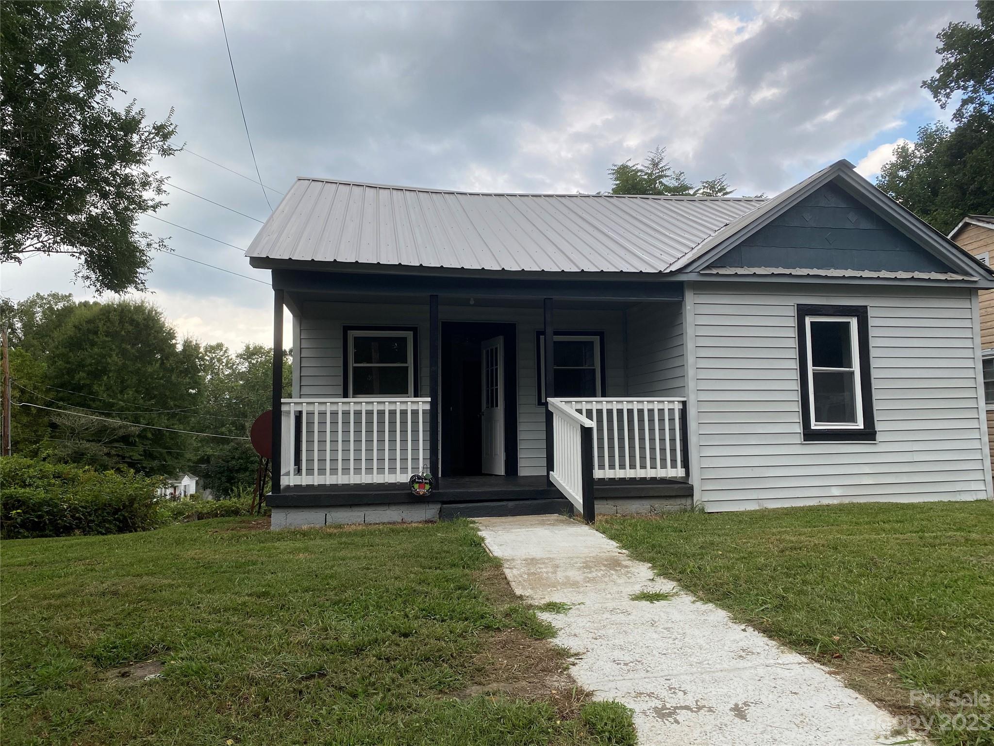 703 Stage Street Northwest Lenoir, NC 28645 - Photo 17 of 17 a front view of a house with a garden