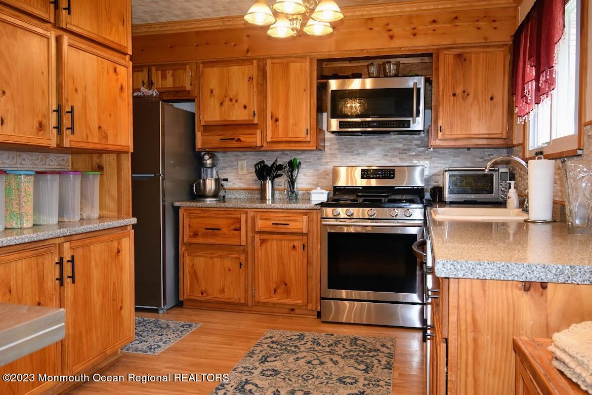 40 Alan Terrace Howell, NJ 07731 - Photo 14 of 48 a kitchen with stainless steel appliances granite countertop a stove top oven a sink dishwasher and granite counter top
