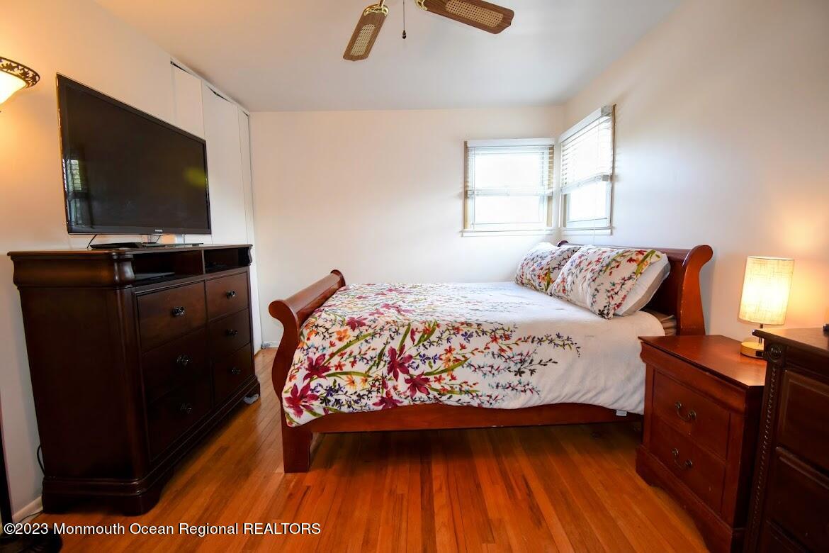 40 Alan Terrace Howell, NJ 07731 - Photo 26 of 48 a bedroom with a bed and a flat tv screen on dresser