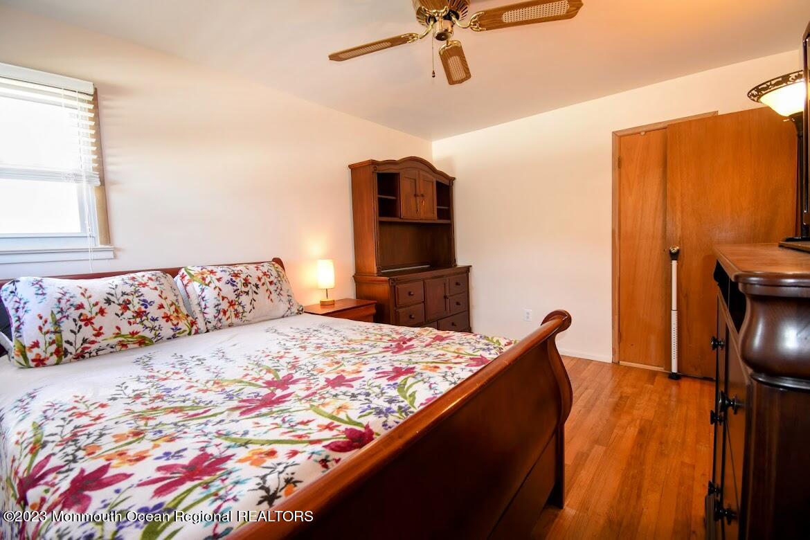 40 Alan Terrace Howell, NJ 07731 - Photo 27 of 48 a bedroom with a bed and wooden floor
