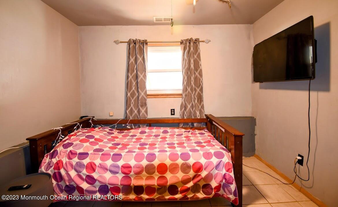 40 Alan Terrace Howell, NJ 07731 - Photo 29 of 48 a bedroom with a bed and a flat screen tv