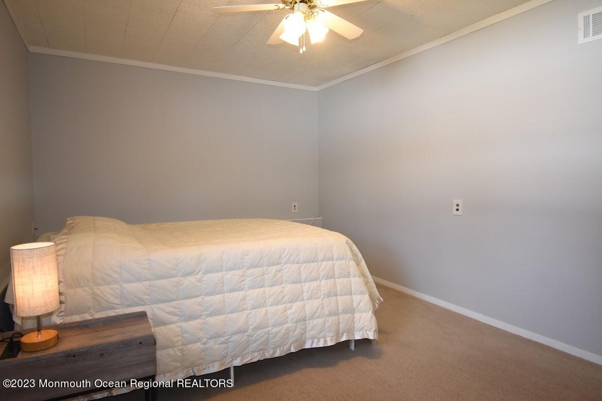 40 Alan Terrace Howell, NJ 07731 - Photo 30 of 48 a bedroom with a bed and a lamp with the table