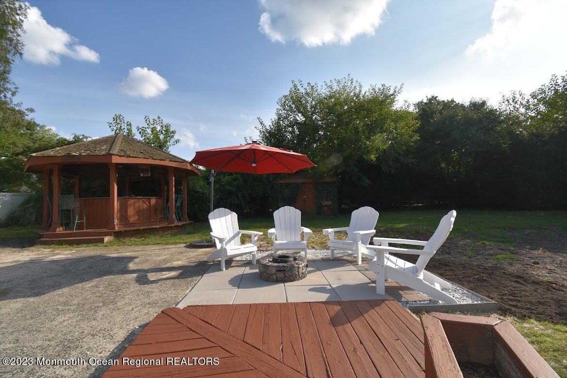 40 Alan Terrace Howell, NJ 07731 - Photo 44 of 48 a view of a patio with table and chairs under an umbrella