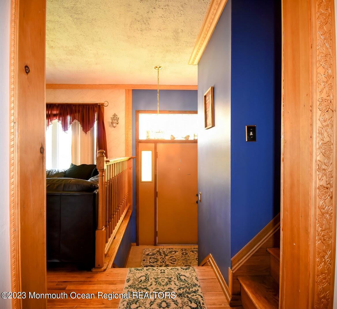 40 Alan Terrace Howell, NJ 07731 - Photo 6 of 48 a view of a hallway with wooden floor and a bathroom