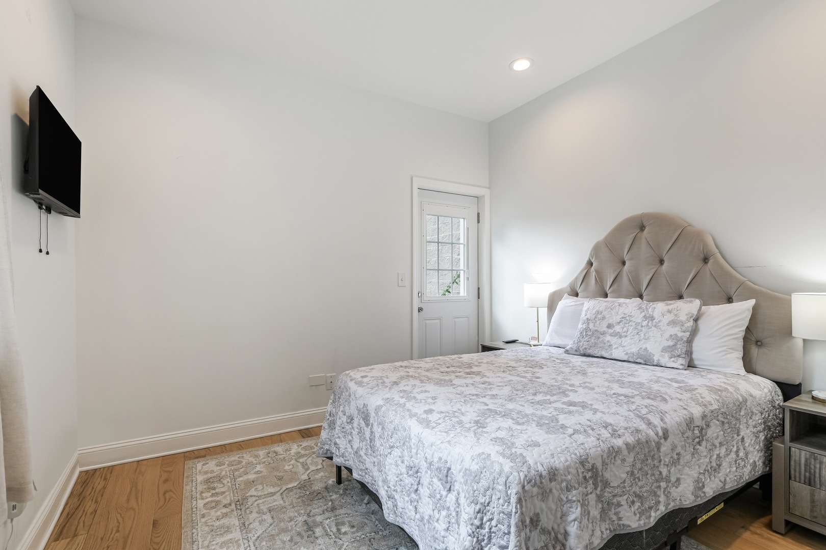 4244 South Prairie Avenue Chicago, IL 60653 - Photo 4 of 5 a bedroom with a bed and a flat screen tv