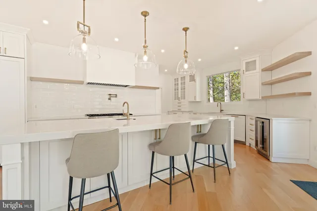 a spacious bathroom with a double vanity sink a large mirror a bathtub and window