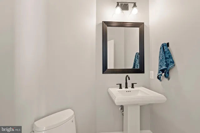 a view of an empty room with wooden floor and closet