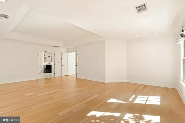 a balcony with wooden floor and yard in the back