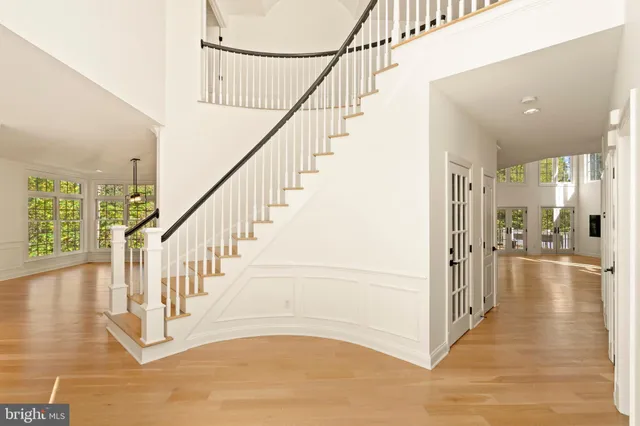 a kitchen with granite countertop white cabinets and white stove