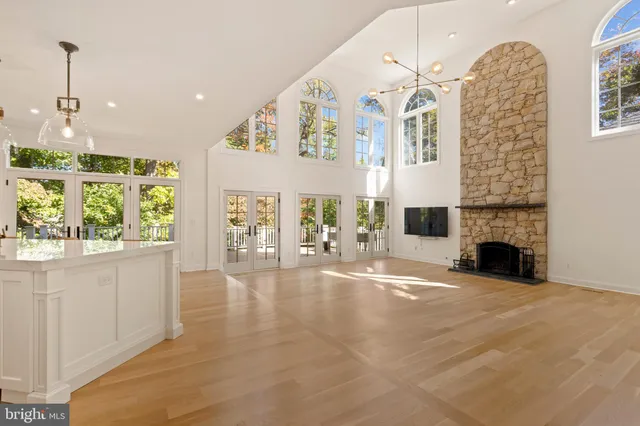 a kitchen with stainless steel appliances white cabinets and a window
