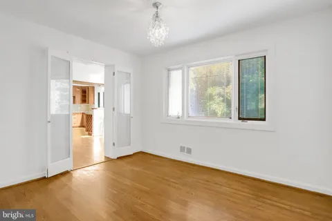 a kitchen with stainless steel appliances kitchen island granite countertop a refrigerator and cabinets
