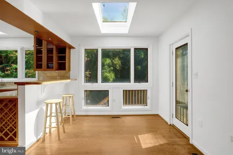 a view of a livingroom with wooden floor and furniture