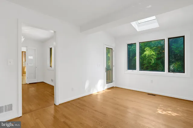 a view of walk in closet with empty racks