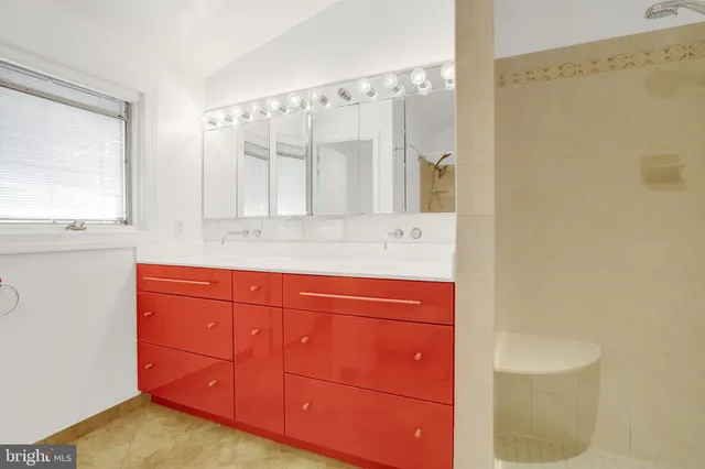 a bathroom with a granite countertop sink a toilet and shower